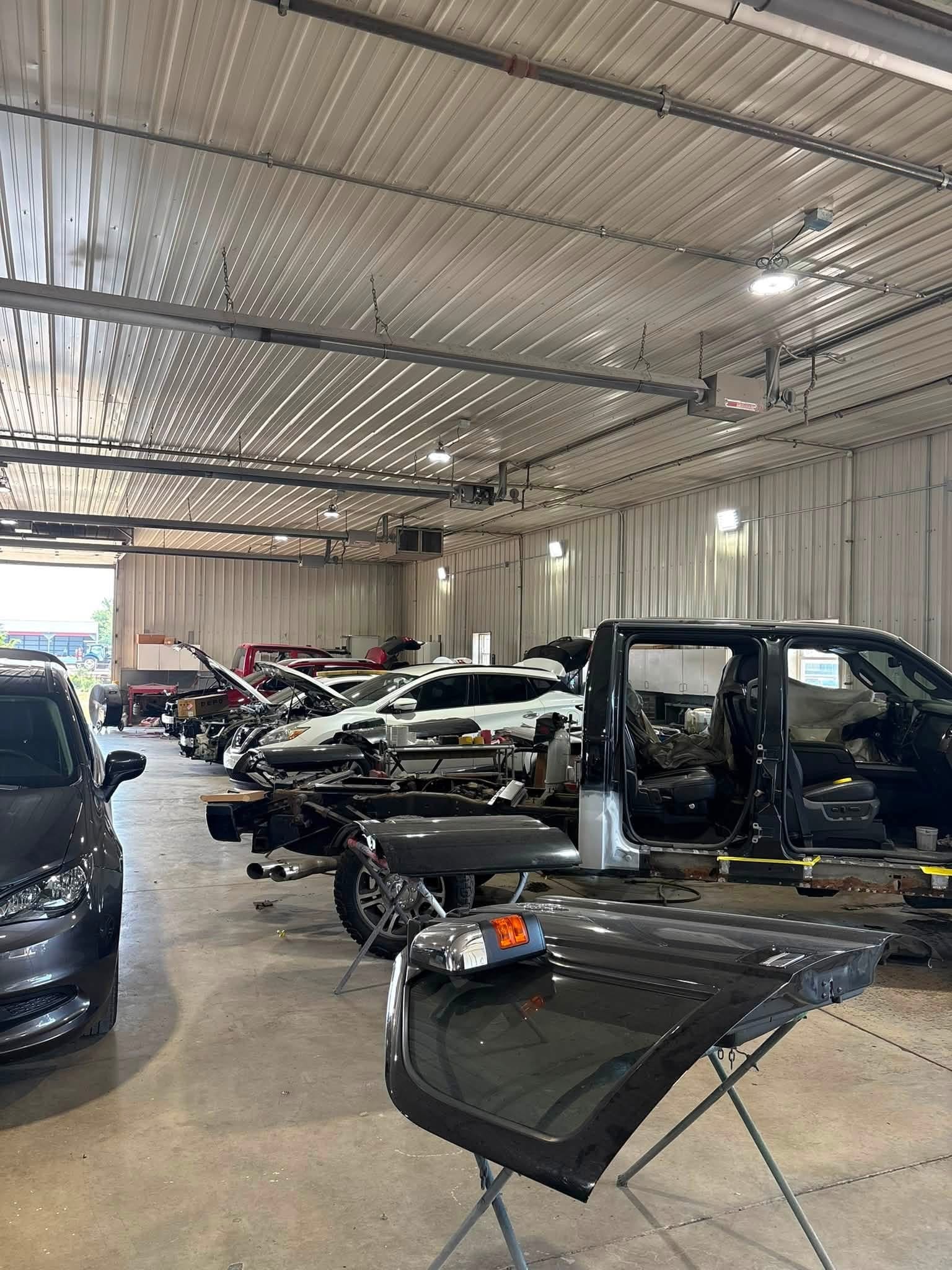 Collision Repair in Progress — Vehicles move through different stages of disassembly, body repair and reassembly inside our West Union, Ohio collision center.